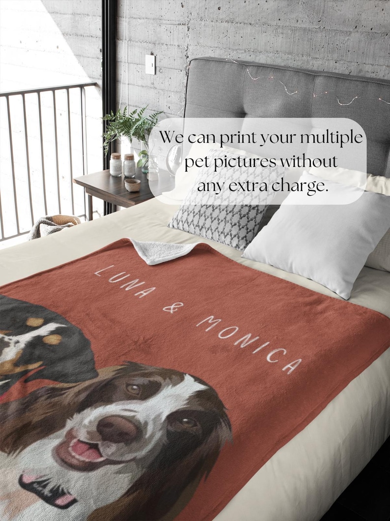 May include: A red fleece blanket with two dog portraits, one of a brown and white dog and one of a black and brown dog. The blanket has the text "LUNA & MONICA" printed on it.