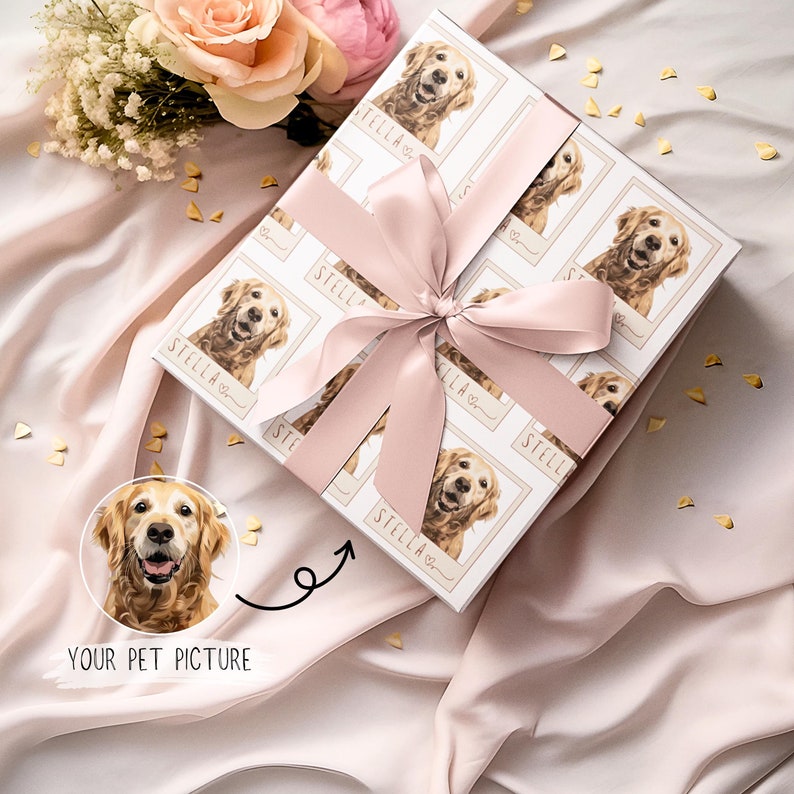 May include: A white gift box with a pink ribbon and a repeating pattern of a golden retriever dog with the name "Stella" printed on each image. The box is wrapped in a pink and white patterned paper.