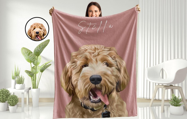 May include: A pink fleece blanket with a personalized illustration of a dog with the name "Stella" written in white cursive.