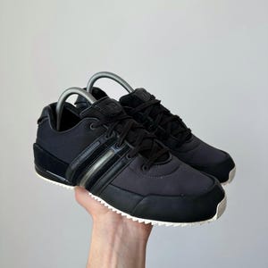 May include: A rustic wooden sign with the text "Welcome to our home" in white lettering. The sign features a distressed finish and a simple, inviting design, perfect for a front porch or entryway.