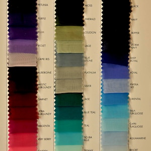 May include: A color chart with 18 rows of fabric swatches. Each row has a fabric swatch and a name for the color. The colors range from dark purple to light blue. The names of the colors are: Petunia, Purple, Plum, Violet, Capri Iris, Aubergine, Mystic Burgundy, Garnet, Ultra Burgundy, Magenta, Very Berry, Garden Fuchsia, Beauty, Moss, Emerald, Celadon, Sage, Blue Stone, Platinum, Silver, Jade, Blue Teal, Teal, Scuba Blue, Tiffany Blue, Ice Mint, Black, Navy, Skipper, Storm Navy, Deep Royal, Royal, Riviera Sky, Oriental, Baja Turquoise, Capri Turquoise, Aquamarine, Resort Blue, Ice Blue.