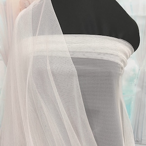 English Netting fabric.. 54 wide   100% poly. IVORY . sold by the yard.. wedding dress, formal wear, home decor
