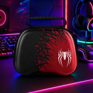 May include: A black and red hard-shell carrying case featuring a white spider emblem on the front. The case has a textured surface, a black top handle, and a zip closure. The design includes a black web-like pattern transitioning into red.