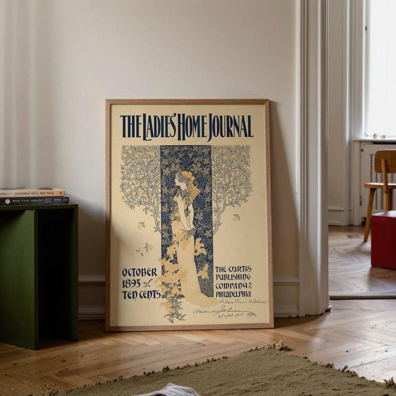 Vintage Art Nouveau poster showing a delicate female figure standing among tall decorative trees and floral patterns, surrounded by butterflies, with elegant text reading “The Ladies’ Home Journal” and publication details from 1895. The artwork has soft cream and blue tones, an ornate decorative style and a refined feminine feel.