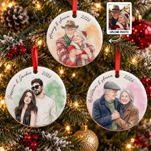 May include: Three round white ceramic ornaments featuring custom watercolor-style illustrations of couples. Each ornament displays names and the year 2026 in black script. The designs include a couple in winter sweaters, a couple in casual attire, and a couple in coats.