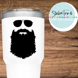 May include: White Yeti tumbler with a black silhouette of a bearded man wearing sunglasses. The text "YETI" is printed on the tumbler. The text "BEARDED MAN DECAL" is printed below the tumbler.