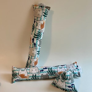 May include: A white ceramic mug with a black handle and the text "But First, Coffee" in a black, handwritten-style font. The mug is on a white surface.