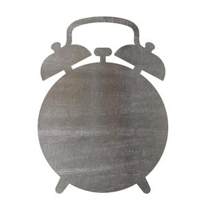 May include: A flat, gray, alarm clock-shaped cutout made of wood with a visible grain texture. The object features a circular main body, two bell-shaped protrusions at the top, a central handle, and two small feet at the bottom base.