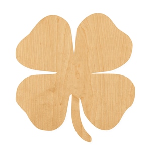 May include: A flat, four-leaf clover cutout made of light-colored wood with a visible natural grain pattern. The shape features four rounded, symmetrical lobes and a single, slightly curved stem extending from the bottom center of the object.