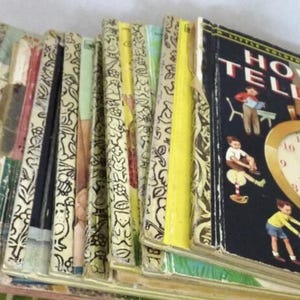 May include: A collection of vintage Little Golden Books with colorful covers. The book spines show a variety of patterns and colors, with one book titled "How to Tell Time" featuring illustrations of children and a clock.