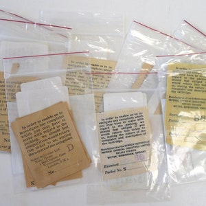 May include: A close-up of several small, clear plastic bags containing small pieces of paper with text. The text on the paper includes the words "Imperial Chemical Industries Limited" and "Witton, Birmingham, England".