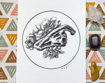 May include: Black and white ink drawing of a skull with flowers in a circle. The skull is surrounded by flowers and leaves. The drawing is on a white background.