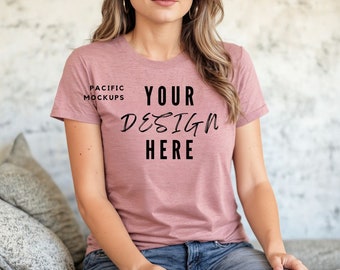 May include: A pink t-shirt with the text "YOUR DESIGN HERE" on the front. The shirt is made of a soft, comfortable material and has a relaxed fit.