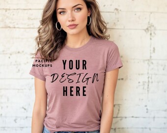 May include: A mauve colored t-shirt with short sleeves and a crew neck. The shirt has the text "YOUR DESIGN HERE" printed on the front.