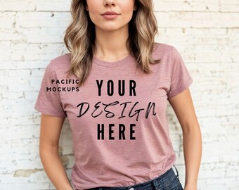 May include: A mauve colored t-shirt with the text "YOUR DESIGN HERE" printed on the front. The t-shirt is made of a soft, comfortable material and is perfect for everyday wear.