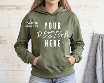 May include: A green hooded sweatshirt with the text "YOUR DESIGN HERE" printed on the front. The text is in a white handwritten font.