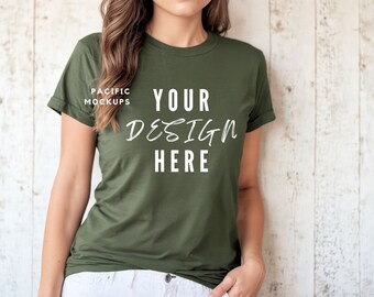 May include: A green t-shirt with short sleeves and a crew neck. The shirt has the text "YOUR DESIGN HERE" printed on the front in white.