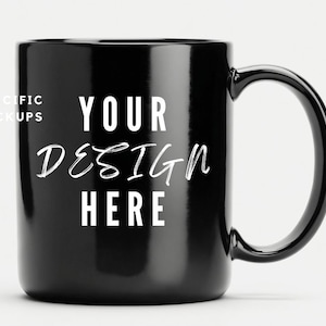 May include: A black ceramic mug with a white inscription that reads "YOUR DESIGN HERE".