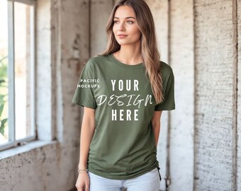 May include: A woman wearing a green t-shirt with the text "YOUR DESIGN HERE" printed on the front. The t-shirt is a relaxed fit and has a slightly distressed look.