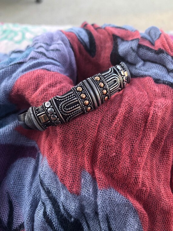 Silver and gold cuff bracelet.