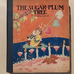 May include: A vintage hardcover book titled The Sugar-Plum Tree and Other Verses by Eugene Field. The cover features a colorful illustration of a child holding a yellow pillow, a gingerbread animal, and various candy-like shapes on a blue and orange background.