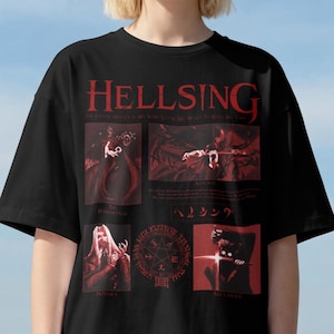 May include: A black short-sleeve t-shirt featuring a red graphic print from the anime Hellsing. The design includes the title text, multiple character illustrations, a circular occult symbol, and Japanese characters arranged in a grid layout.