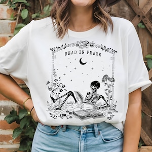 Read in Peace Shirt, Skeleton Halloween T-Shirt, Book Lover Tee, Spooky Season Gifts, Halloween Bookish Gifts, Skeleton Reading Book T-Shirt
