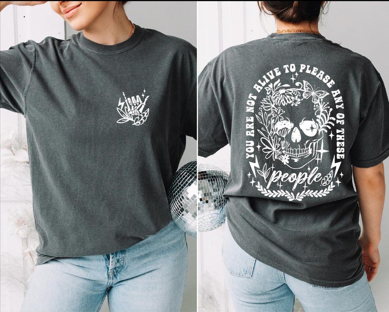 a woman wearing a t - shirt with a skull on it