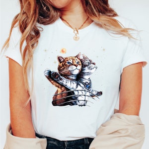 a woman wearing a t - shirt with a picture of two cats on it