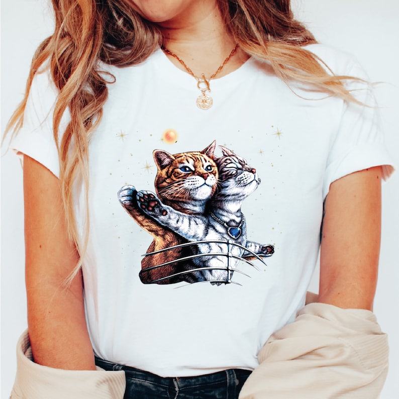 a woman wearing a t - shirt with a picture of two cats on it