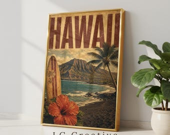May include: A rectangular wall art print in a gold frame featuring the word HAWAII in large dark letters. The image displays a coastal landscape with a mountain, a palm tree, a surfboard, and a large orange hibiscus flower in the foreground.