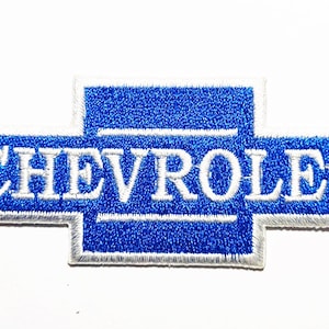 May include: Embroidered blue Chevrolet logo patch with white stitching. The Chevrolet emblem is a stylized bow tie shape with the brand name in white capital letters.