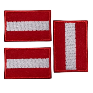 May include: Three embroidered patches featuring the flag of Latvia. The patches are rectangular with a red background and a white horizontal stripe. One patch is vertical. The patches are bordered with red stitching.
