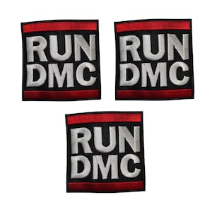 May include: Three embroidered patches featuring the text "RUN DMC" in white block letters on a black base. Each patch has a red border at the top and bottom.