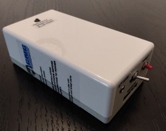 May include: White rectangular box with a black label that reads "READ INSTALLATION INSTRUCTIONS BEFORE CONNECTING TO POWER". The box has two switches, one red and one silver, and a black power cord.