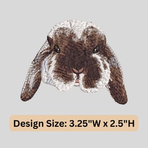 May include: Embroidered patch featuring a brown and white rabbit with floppy ears. The design size is 3.25"W x 2.5"H. The rabbit has detailed stitching, with a pink nose and dark eyes. The patch is likely for clothing or accessories.