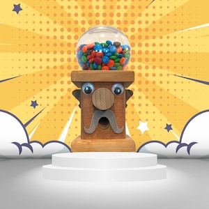 May include: A wooden gumball machine with a cartoon face, a mustache, and a clear plastic top filled with colorful candy. The machine is on a white pedestal against a yellow and white polka dot background.