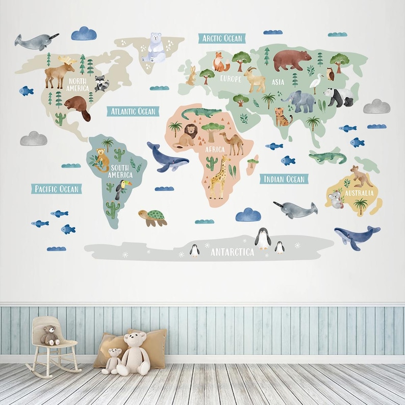 May include: A colorful world map wall decal with animal illustrations for each continent. The map features a light blue background with a beige outline of the continents. The animals are illustrated in a cartoon style and include a polar bear, a moose, a lion, a camel, a kangaroo, a penguin, and a whale.
