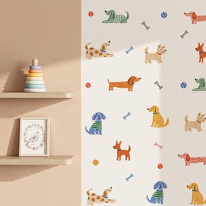 May include: A wall decal set featuring various illustrated dogs in different colours and breeds, interspersed with small colourful balls and bone shapes on a light background, alongside a wooden stacking toy and a framed bird print on shelves.