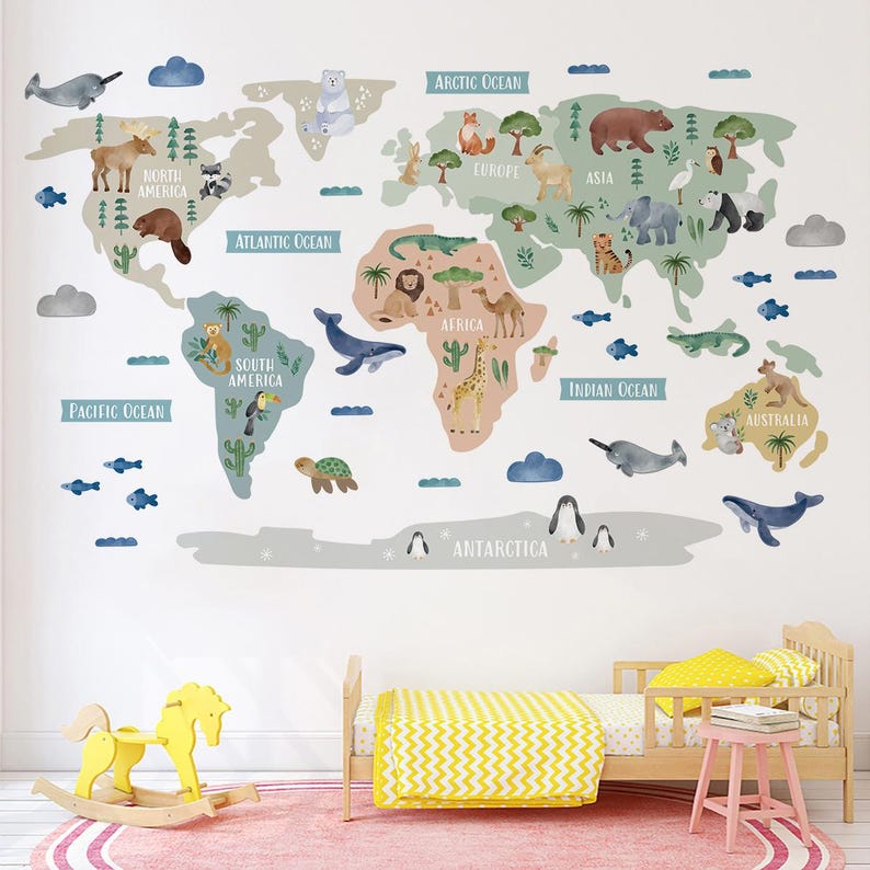 May include: A colorful world map wall decal with animal illustrations for each continent. The map is on a white wall with a yellow and white striped bedspread and a pink rug.