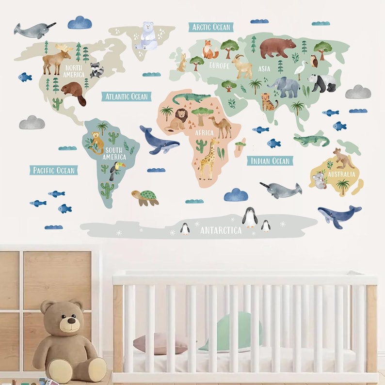 May include: A colorful world map wall decal with animal illustrations for each continent. The map features a blue whale, a giraffe, a penguin, a kangaroo, a polar bear, a lion, a toucan, a turtle, a narwhal, a camel, an elephant, a bear, a fox, a deer, a beaver, a raccoon, a crocodile, and a koala.