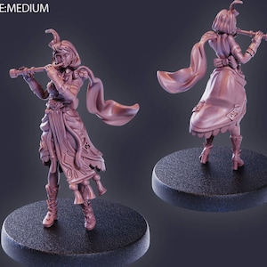 May include: A detailed figurine of a woman playing a flute. The figure is dressed in a flowing gown with intricate designs and a cape. The figurine is a muted pink colour and stands on a black circular base. The text "SIZE:MEDIUM" is in the top left corner.
