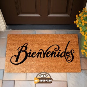 May include: A brown coir doormat with the word "Bienvenidos" written in black cursive script.