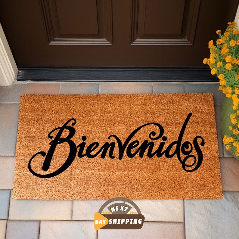 May include: A brown coir doormat with the word "Bienvenidos" written in black cursive script.