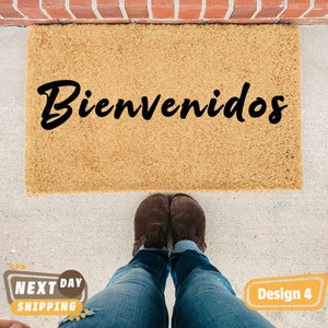 May include: A brown coir doormat with the word "Bienvenidos" written in black cursive lettering.