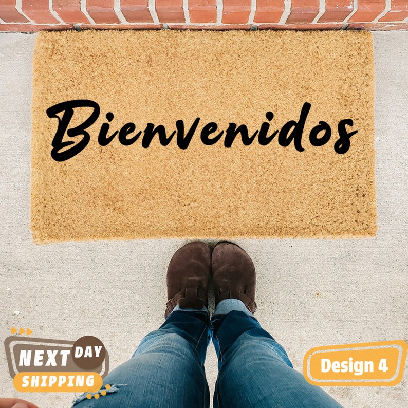 May include: A brown coir doormat with the word "Bienvenidos" written in black cursive lettering.