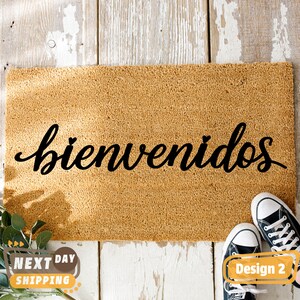 May include: A brown coir doormat with the word "bienvenidos" written in black cursive script.