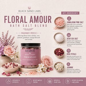 May include: A jar of Black Sand Labs Floral Amour bath salt blend with a black lid, labeled 500g / 16.8oz. The product is surrounded by pink roses, white flowers, and small bowls containing Himalayan pink salt, Dead Sea salt, rose petals, and jasmine.