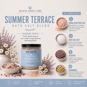 May include: A jar of Black Sand Labs Summer Terrace bath salt blend with a light blue label. The product is displayed with small bowls of Himalayan pink salt, Dead Sea salt, heather, and chamomile, alongside fresh flowers and descriptive text.