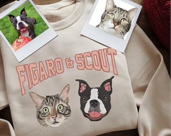 May include: A beige sweatshirt with the text "FIGARO & SCOUT" embroidered in pink. There are two embroidered images of pets, a cat and a dog, on the sweatshirt.